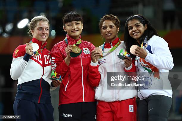 Silver medalist Valeriia Koblova Zholobova of Russia, gold medalist Kaori Icho of Japan, bronze medalist Marwa Amri of Tunisia and bronze medalist...