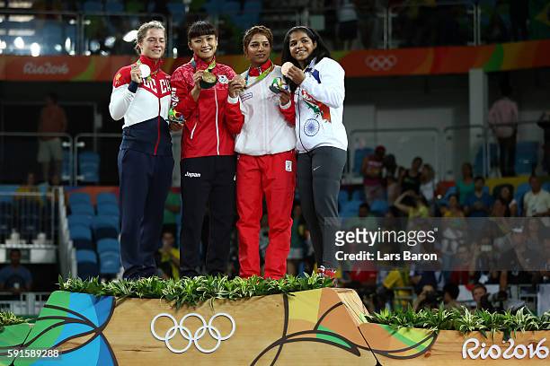 Silver medalist Valeriia Koblova Zholobova of Russia, gold medalist Kaori Icho of Japan, bronze medalist Marwa Amri of Tunisia and bronze medalist...