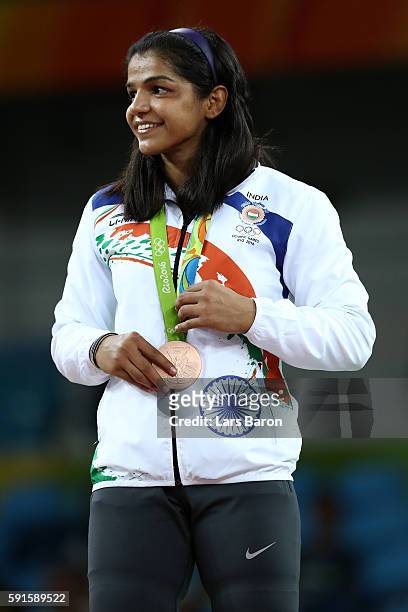 Bronze medalist Sakshi Malik of India stands during the medal ceremony after the Women's Freestyle 58 kg competition on Day 12 of the Rio 2016...