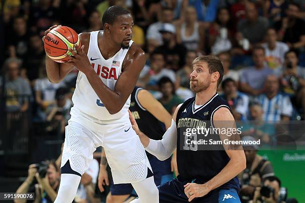 Kevin Durant of United States with the ball against Andres Nocioni of Argentina during the Men's Quarterfinal match on Day 12 of the Rio 2016 Olympic...