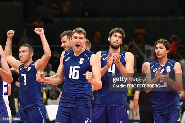 Italy's Oleg Antonov and teammates celebrate after winning their men's quarter-final volleyball match against Iran at Maracanazinho Stadium in Rio de...