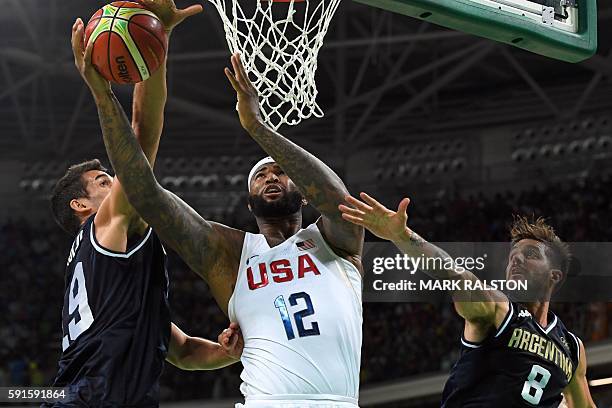 S centre DeMarcus Cousins goes to the basket between Argentina's shooting guard Patricio Garino and Argentina's point guard Nicolas Laprovittola...