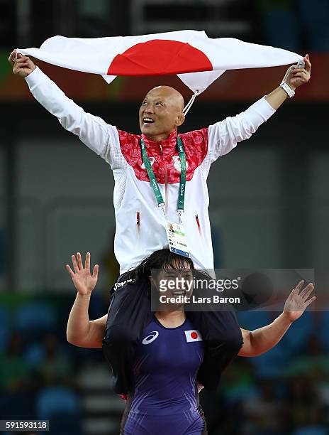 Sara Dosho of Japan celebrates with her coach after defeating Natalia Vorobeva of Russia in the Women's Freestyle 69 kg Gold Medal match on Day 12 of...