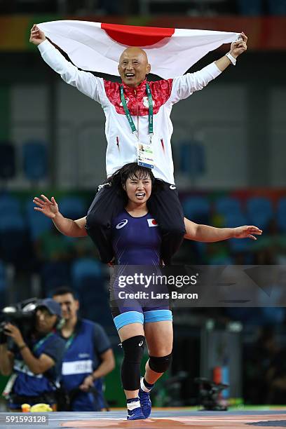 Sara Dosho of Japan celebrates with her coach after defeating Natalia Vorobeva of Russia in the Women's Freestyle 69 kg Gold Medal match on Day 12 of...