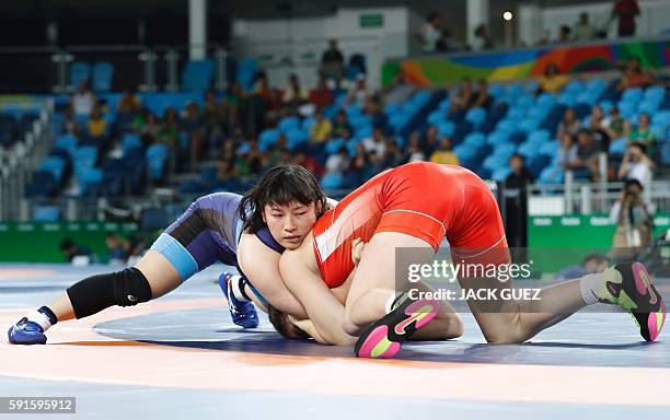 Japan's Sara Dosho wrestles with Russia's Natalia Vorobeva in their women's 69kg freestyle final match on August 17 during the wrestling event of the...