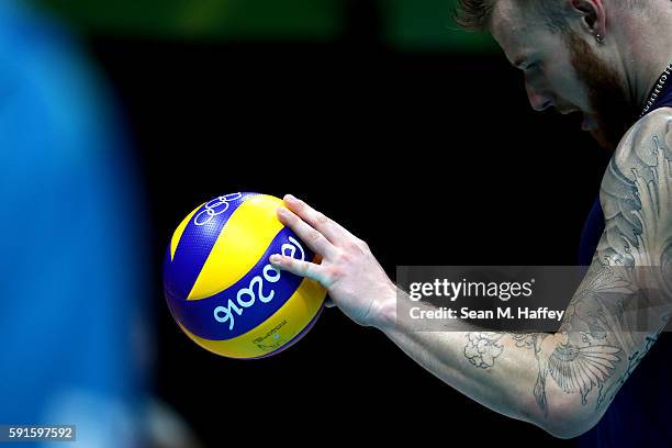 Ivan Zaytsev of Italy holds a ball against Iran during the Men's Quarterfinal Volleyball match on Day 12 of the Rio 2016 Olympic Games at...