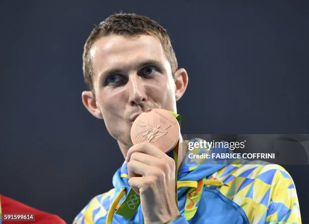 Ukraine's Bohdan Bondarenko poses during the podium ceremony for the men's High Jump during the athletics event at the Rio 2016 Olympic Games at the...