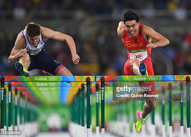 Lawrence Clarke of Great Britain and Wenjun Xie of China compete during the Men's 110m Hurdles Round 1 on Day 10 of the Rio 2016 Olympic Games at the...