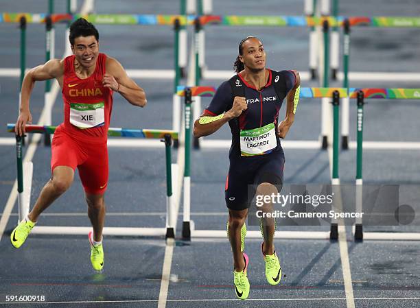 Wenjun Xie of China and Pascal Martinot-Lagarde of France compete during the Men's 110m Hurdles Round 1 on Day 10 of the Rio 2016 Olympic Games at...