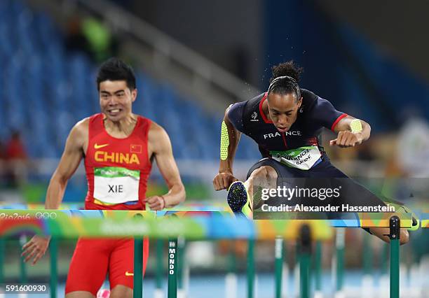 Wenjun Xie of China and Pascal Martinot-Lagarde of France compete during the Men's 110m Hurdles Round 1 on Day 10 of the Rio 2016 Olympic Games at...