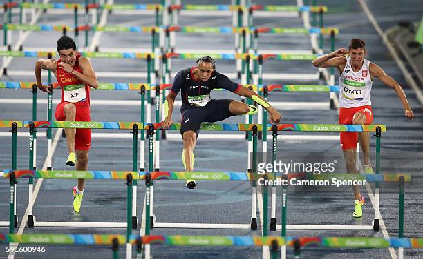 Wenjun Xie of China and Pascal Martinot-Lagarde of France compete during the Men's 110m Hurdles Round 1 on Day 10 of the Rio 2016 Olympic Games at...