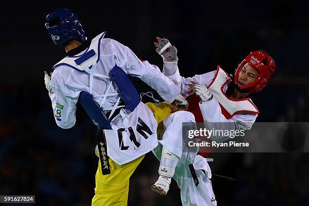 Shuai Zhao of China competes against Tawin Hanprab of Thailand during the Taekwondo Men's -58kg Gold Medal contest during Day 12 of the Rio 2016...