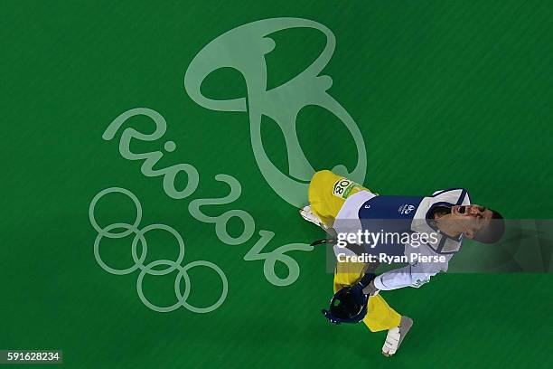 Shuai Zhao of China celebrates after winning gold over Tawin Hanprab of Thailand in the Taekwondo Men's -58kg contest during Day 12 of the Rio 2016...