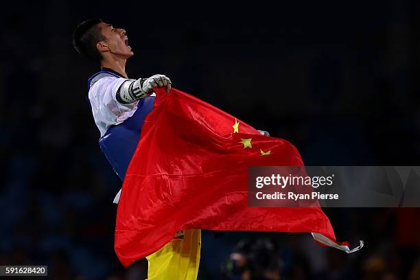 Shuai Zhao of China celebrates after winning gold over Tawin Hanprab of Thailand in the Taekwondo Men's -58kg contest during Day 12 of the Rio 2016...