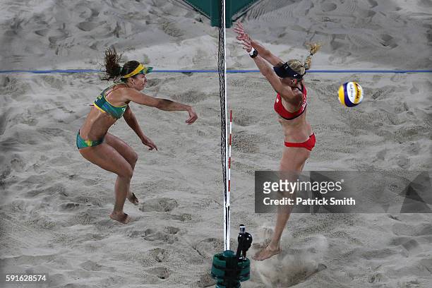 Talita Rocha of Brazil and April Ross of the United States attempt to play a shot during the Beach Volleyball Women's Bronze medal match between...