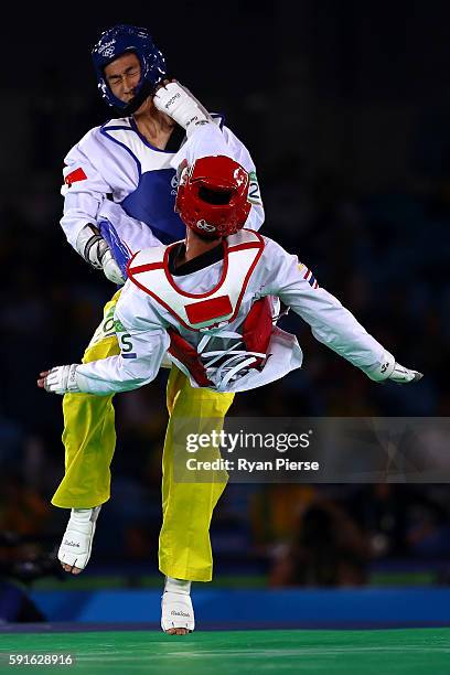 Shuai Zhao of China competes against Tawin Hanprab of Thailand during the Taekwondo Men's -58kg Gold Medal contest during Day 12 of the Rio 2016...