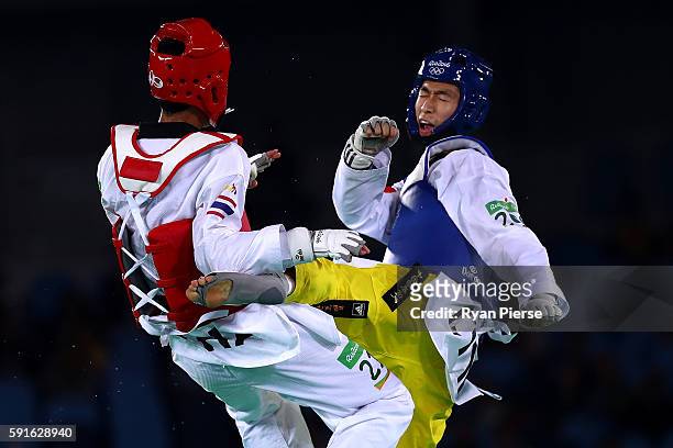 Shuai Zhao of China competes against Tawin Hanprab of Thailand during the Taekwondo Men's -58kg Gold Medal contest during Day 12 of the Rio 2016...