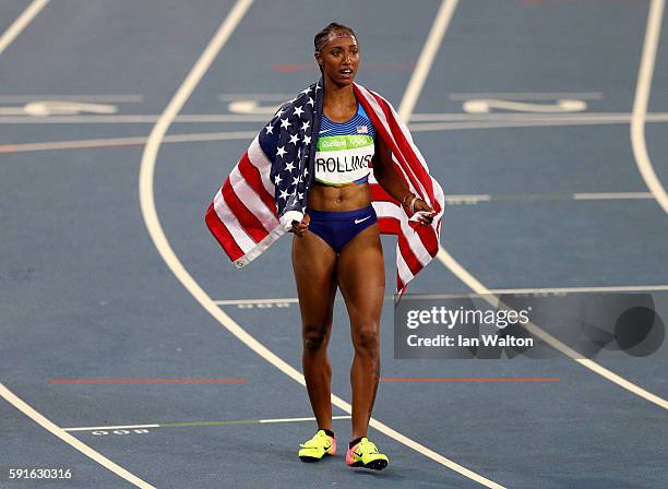 Brianna Rollins of the United States reacts with the American flag after winning the gold medal in the Women's 100m Hurdles Final on Day 12 of the...