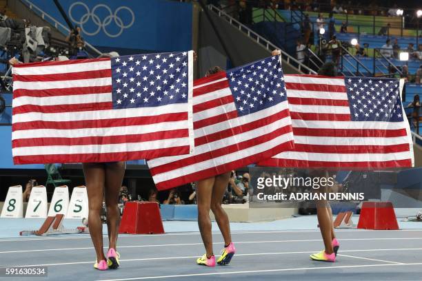 Silver medallist USA's Nia Ali, gold medallist USA's Brianna Rollins and bronze medallist USA's Kristi Castlin celebrate after the Women's 100m...