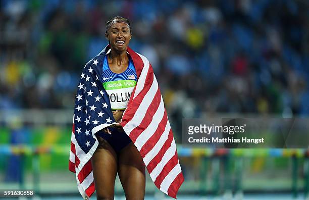 Brianna Rollins of the United States reacts with the American flag after winning the gold medal in the Women's 100m Hurdles Final on Day 12 of the...