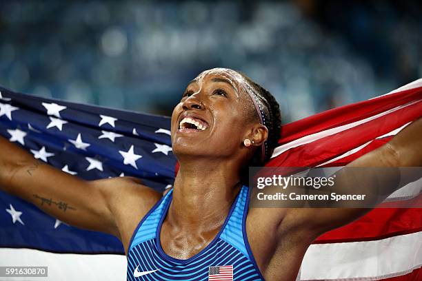Brianna Rollins of the United States celebrates with the American flag after winning the gold medal in the Women's 100m Hurdles Final on Day 12 of...