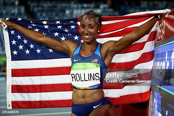 Brianna Rollins of the United States celebrates with the American flag after winning the gold medal in the Women's 100m Hurdles Final on Day 12 of...
