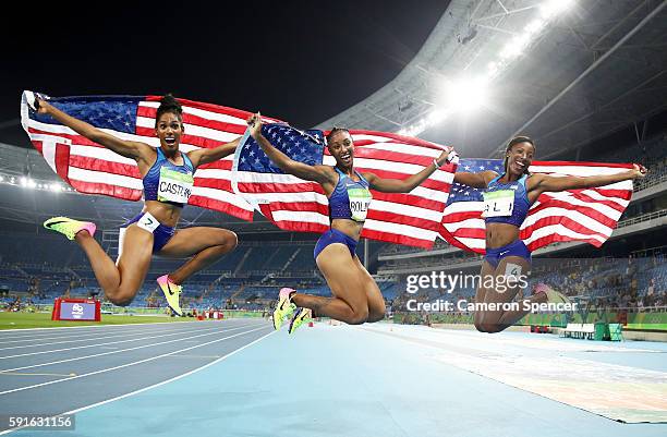 Bronze medalist Kristi Castlin, gold medalist Brianna Rollins and silver medalist Nia Ali of the United States celebrate with American flags after...