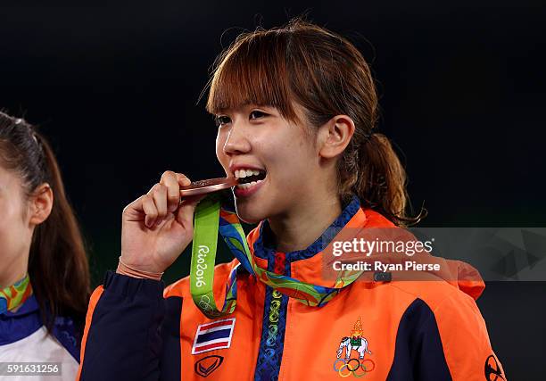 Bronze medalist Panipak Wongpattanakit of Thailand stands on the podium during the medal ceremony for the Taekwondo Women's -49kg contest during Day...