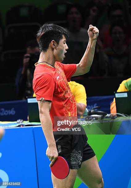 Zhang Jike of China celebrates with Xuxin of China during the Men's Table Tennis gold medal match against Koki Niwa and Maharu Yoshimura of Japan at...