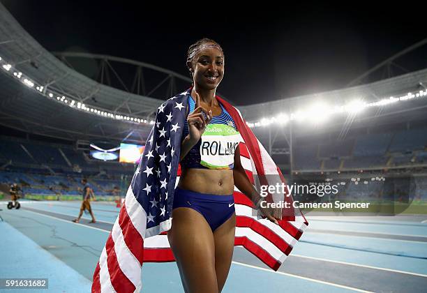 Brianna Rollins of the United States poses with the American flag after winning the gold medal in the Women's 100m Hurdles Final on Day 12 of the Rio...