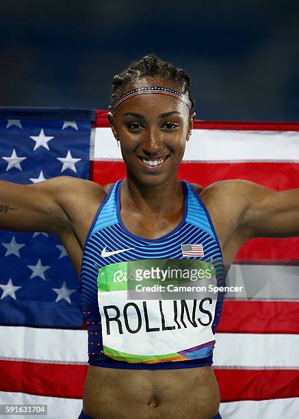 Brianna Rollins of the United States poses with the American flag after winning the gold medal in the Women's 100m Hurdles Final on Day 12 of the Rio...