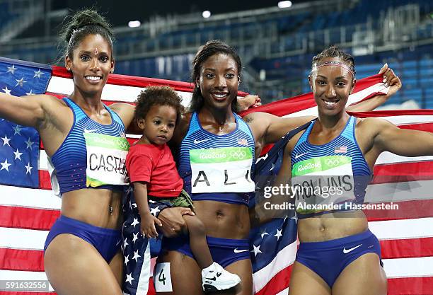 Bronze medalist Kristi Castlin, silver medalist Nia Ali and gold medalist Brianna Rollins of the United States pose with Ali's son Titus after the...