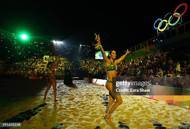 Agatha Bednarczuk Rippel of Brazil and Barbara Seixas de Freitas of Brazil wave to the crowd before the Beach Volleyball Women's Gold medal match...