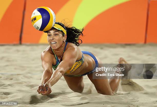 Agatha Bednarczuk Rippel of Brazil plays a shot during the Beach Volleyball Women's Gold medal match against Laura Ludwig of Germany and Kira...