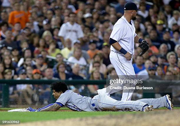 Raul Mondesi of the Kansas City Royals dives into third base past Casey McGehee of the Detroit Tigers for a triple during the eighth inning at...