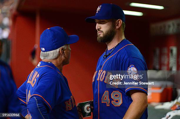 Terry Collins of the New York Mets talks with Jonathon Niese in the dugout after being relieved in the fifth inning of the game against the Arizona...