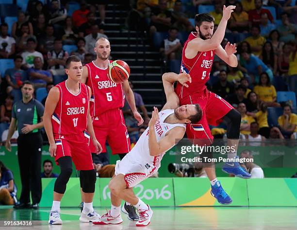 Stefan Markovic of Serbia fouls Bojan Bogdanovic of Croatia against Serbia Nemanja Nedovic of Serbia and Marko Simonovic of Serbia look on during the...