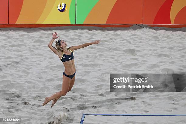 Laura Ludwig of Germany serves the ball during the Beach Volleyball Women's Gold medal match against Agatha Bednarczuk Rippel of Brazil and Barbara...