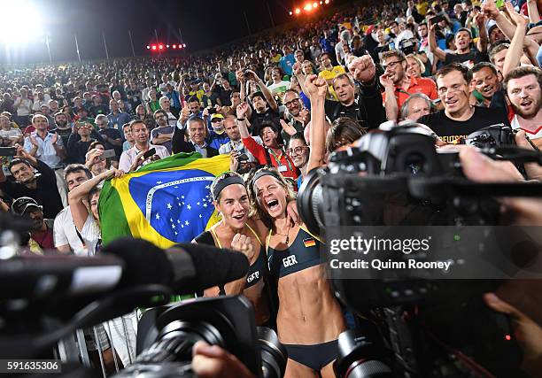 Laura Ludwig and Kira Walkenhorst of Germany celebrate winning gold during the Beach Volleyball Women's Gold medal match against Agatha Bednarczuk...