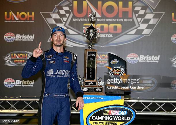 Ben Kennedy, driver of the Jacob Chevrolet, celebrates after winning the NASCAR Camping World Truck Series UNOH 200 at Bristol Motor Speedway on...