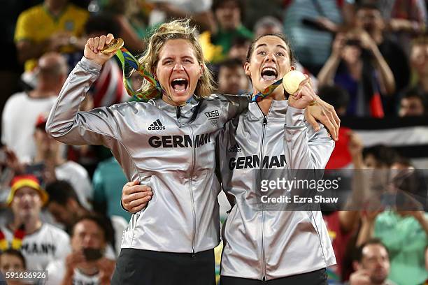 Gold medalists Laura Ludwig and Kira Walkenhorst of Germany celebrate on the podium during the medal ceremony for the Women's Beach Volleyball on day...