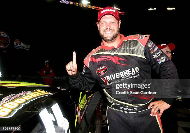Eric Goodale, driver of the GAF Roofing/RBSCorp.com Chevrolet, poses with the winner's sticker after winning the NASCAR Whelen Modified Tours Bush's...