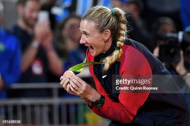 Bronze medalists Kerri Walsh Jennings of the United States celebrates on the podium during the medal ceremony for the Women's Beach Volleyball on day...