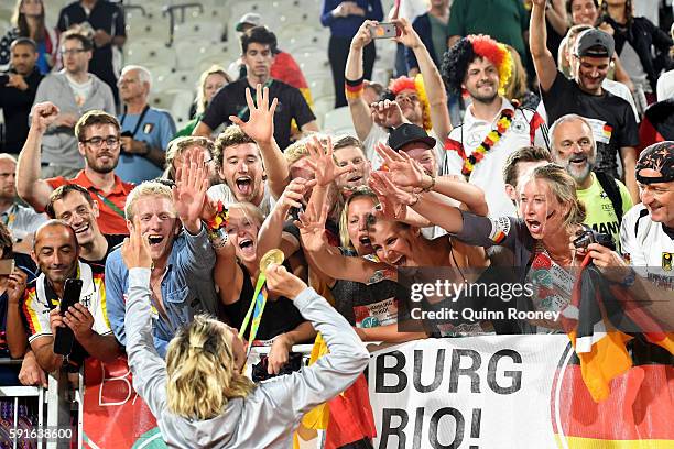 Gold medalist Laura Ludwig of Germany celebrates with the fans during the medal ceremony for the Women's Beach Volleyball on day 12 of the Rio 2016...