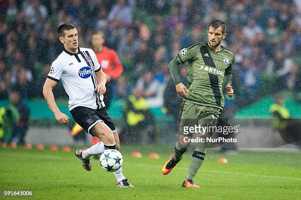 Dane Massey of Dundalk fights for the ball with Lukasz Broz of Legia during the UEFA Champions League Play-Offs 1st leg between Dundalk FC and Legia...