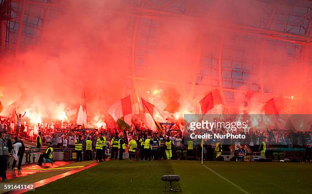 Supporters of Legia Warsaw with flares pictures before the UEFA Champions League Play-Offs 1st leg between Dundalk FC and Legia Warsaw at Aviva...