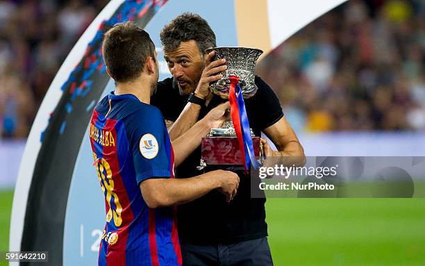 Barcelona's Luis Enrique Martinez holds the trophy of the Spanish Super Cup football match between FC Barcelona and Sevilla FC at Camp Nou Stadium on...