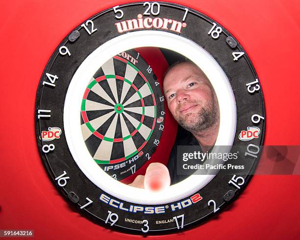 Composite view of professional darts player Raymond van Barneveld and the competition dartboard during a press conference ahead of the Sydney round...