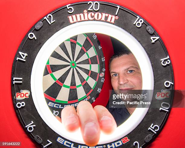 Composite view of professional darts player Gary Anderson and the competition dartboard during a press conference ahead of the Sydney round of the...