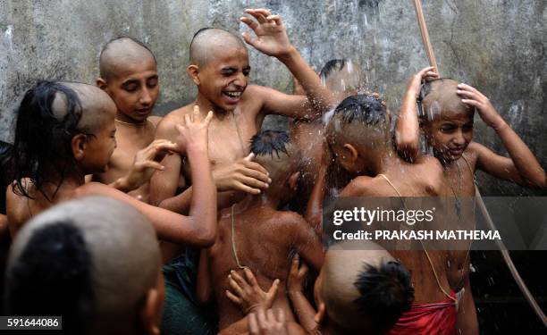 Young Nepalese Hindu priests take a holy bath together as part of a ritual during the Janai Purnima Festival at the Janai Purnima Festival at The...